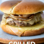 A close up shot of a burger with text on the photo for Pinterest.