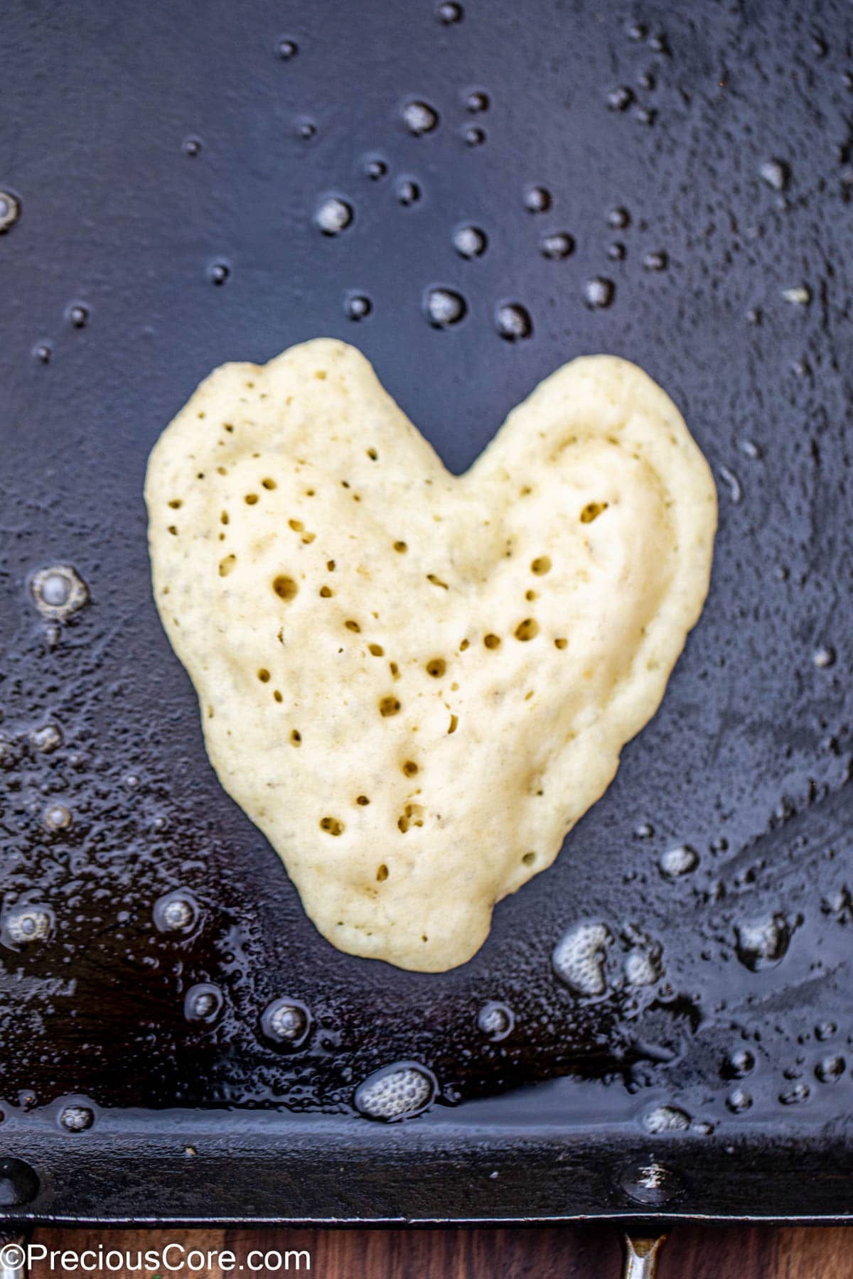 Heart pancake on a griddle.