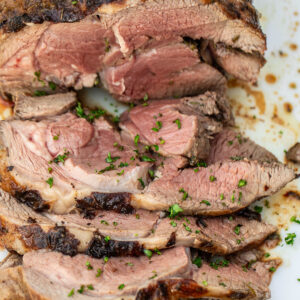 A sliced roasted boneless leg of lamb.