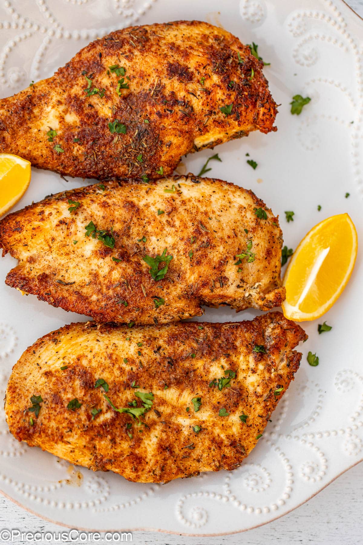 Chicken breasts garnished with parsley.
