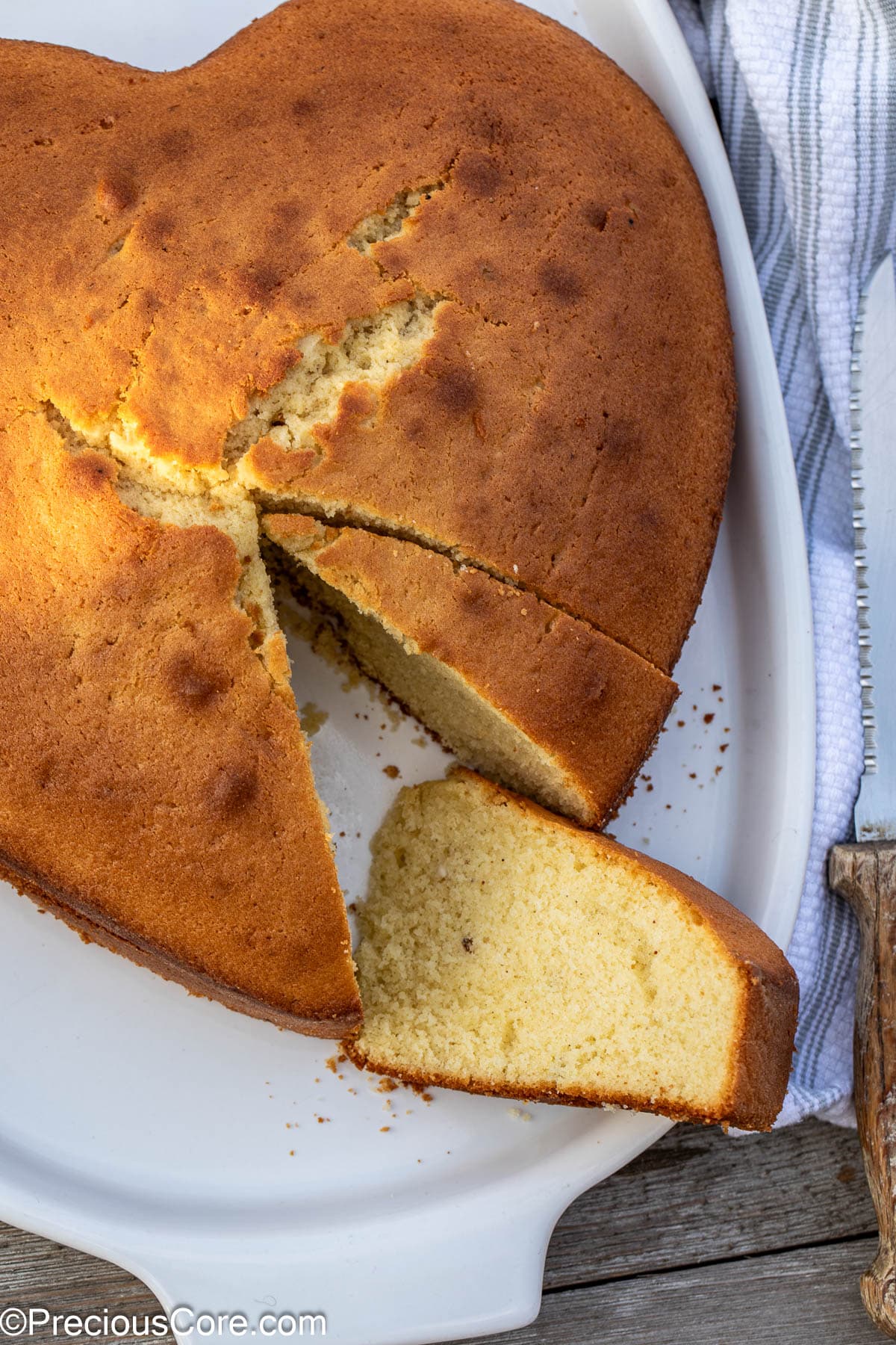 Plain cake with slices taken out.