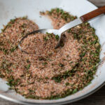 A spoon grabbing some of the best seasoning for French fries.