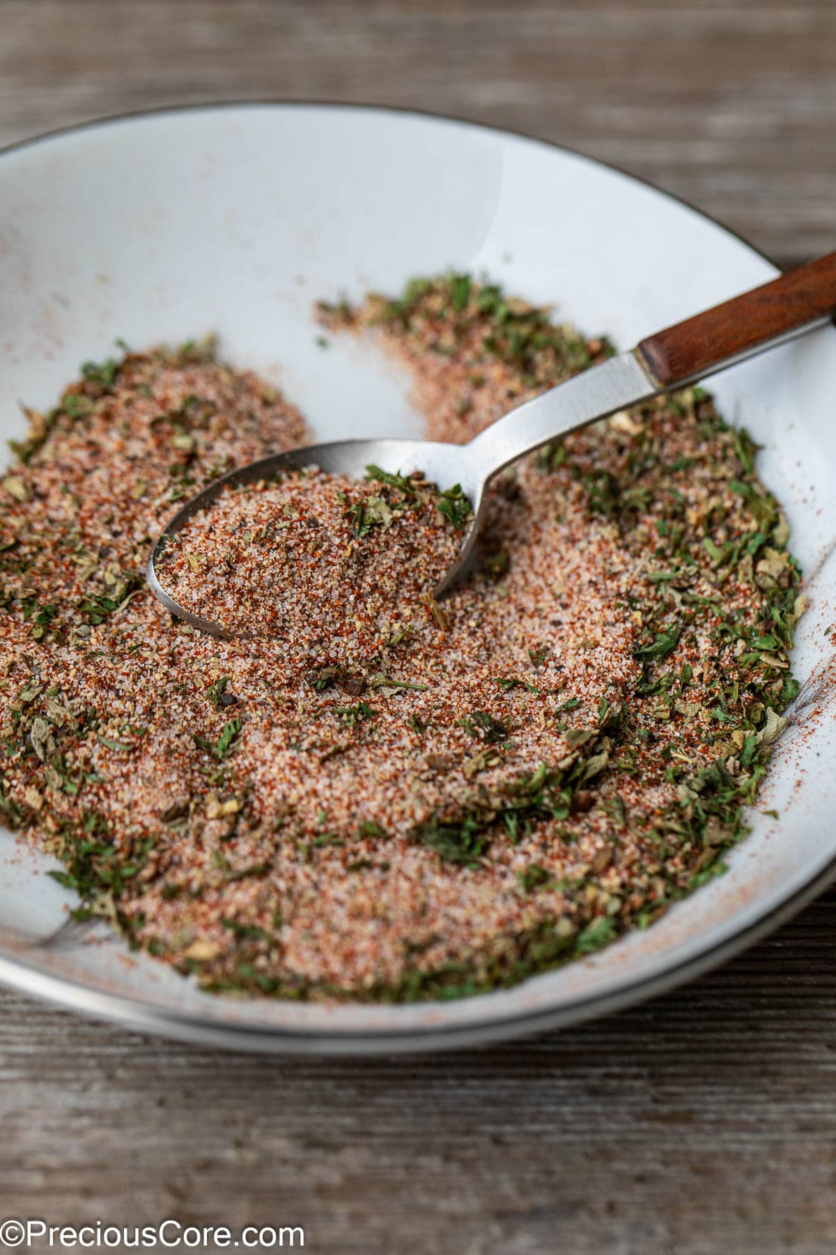 A spoon grabbing some of the best seasoning for French fries.