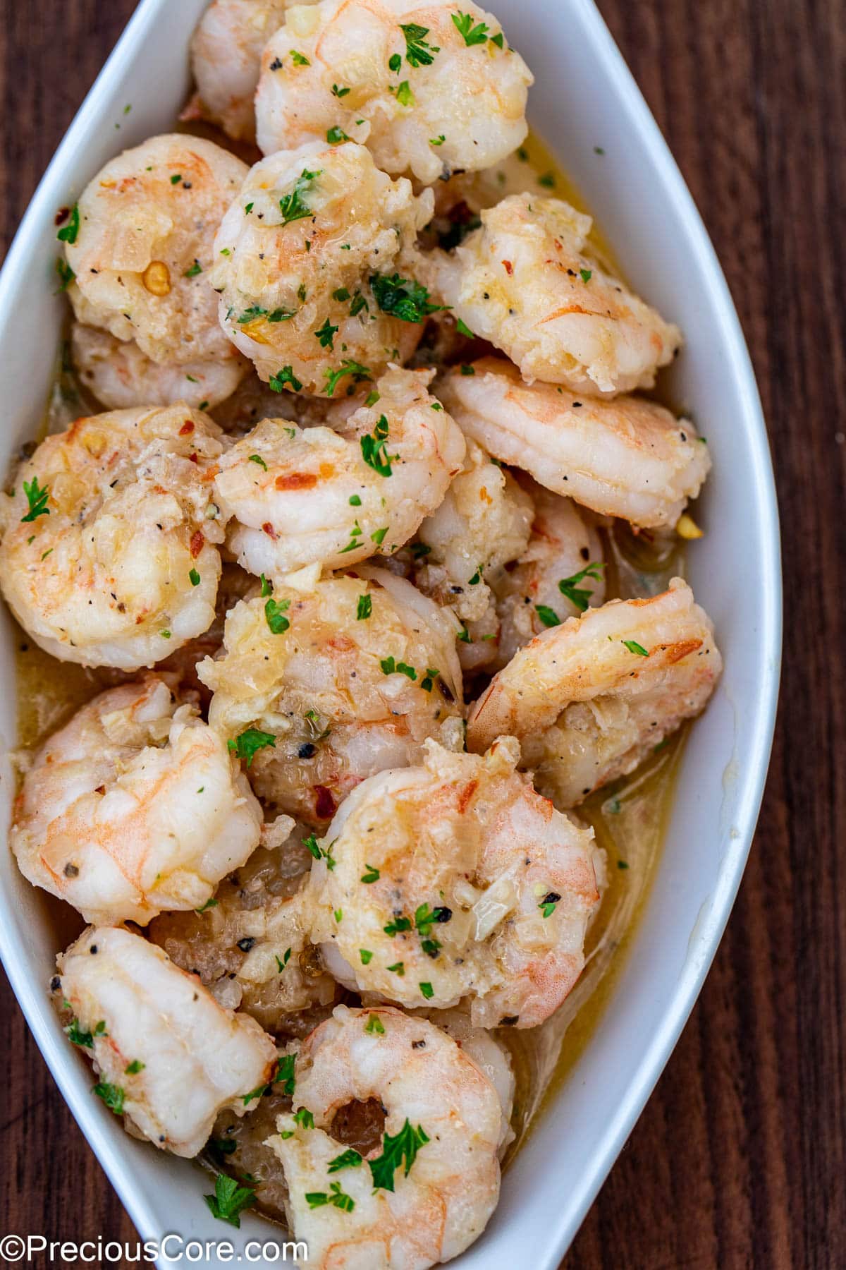 A serving of shrimp in white wine sauce.