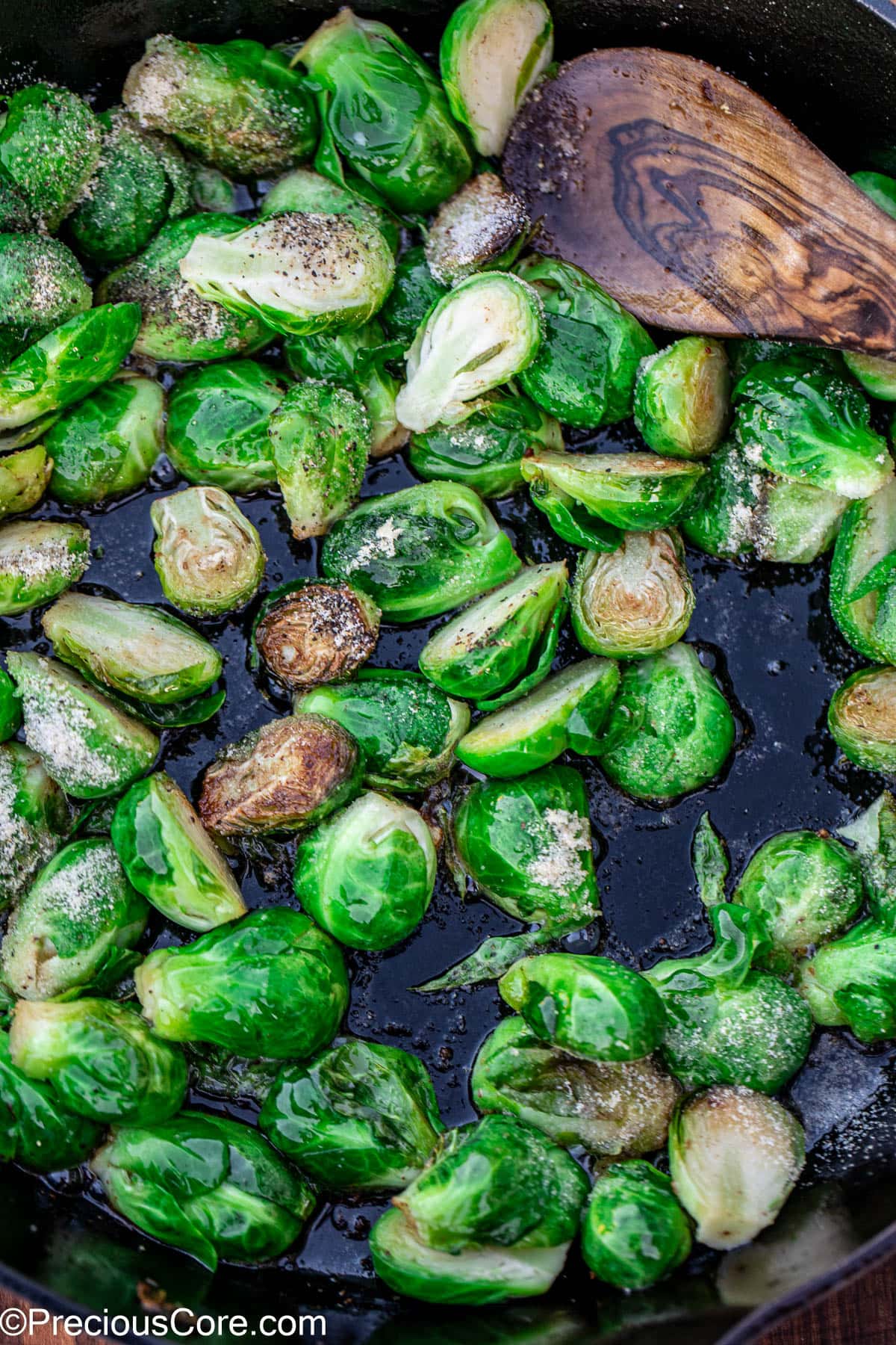 Bright green Brussels sprouts sprinkled with salt and pepper.