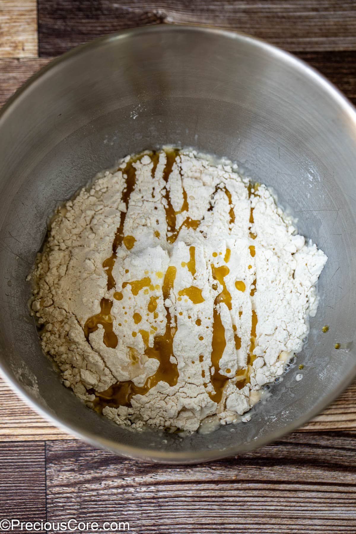 Flour and other pizza ingredients in a mixing bowl.