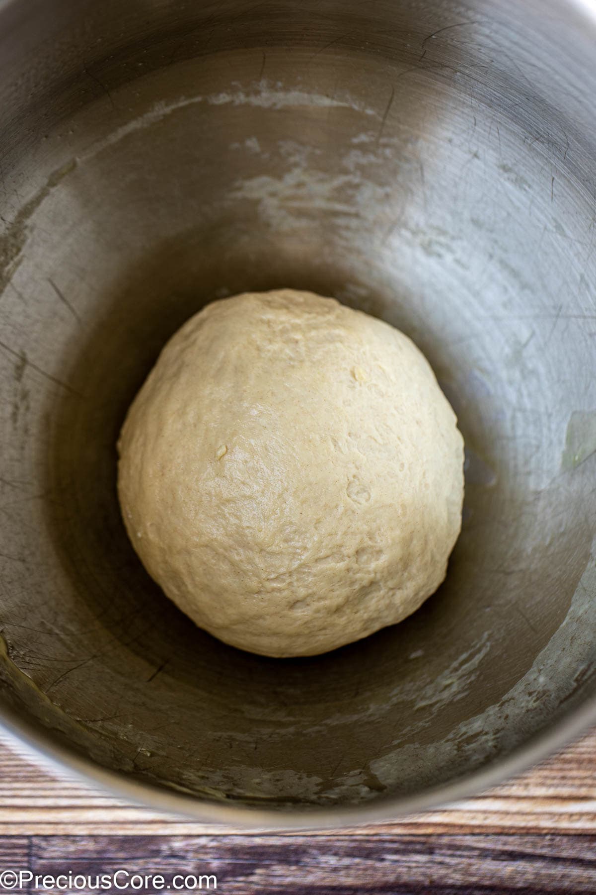 Kneaded dough for pizza in an oiled bowl.