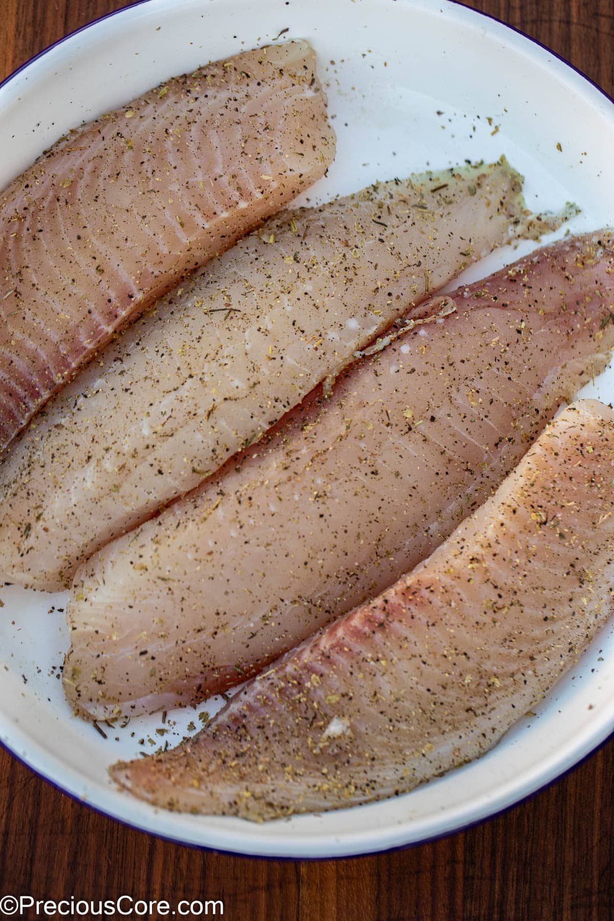 Raw seasoned fish fillets.