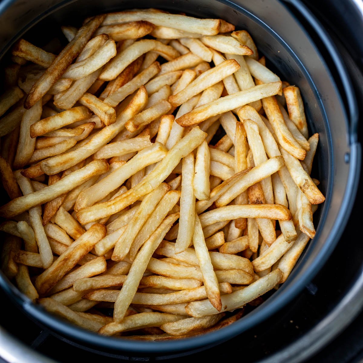 Square image of frozen fries cooked in air fryer.