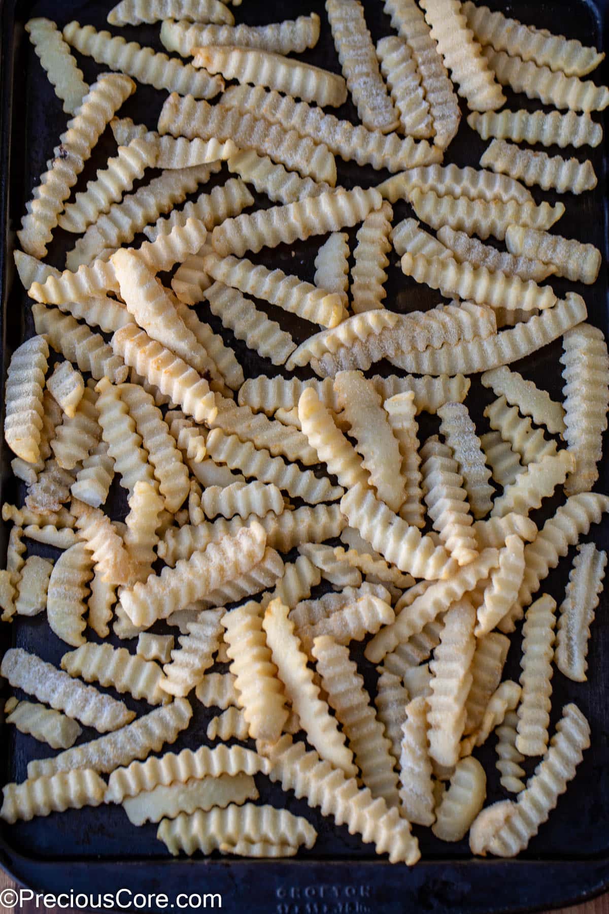 Frozen fries on a sheet pan.