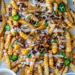 Loaded French Fries on a sheet pan.