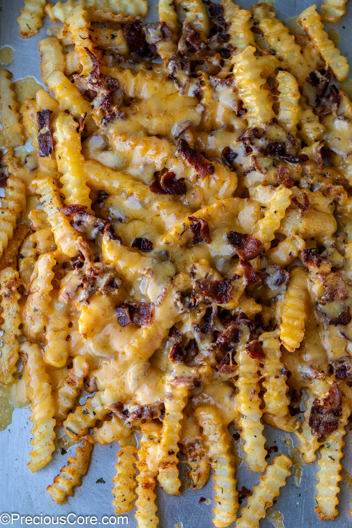 Fries covered with melted cheese and crumbled bacon.