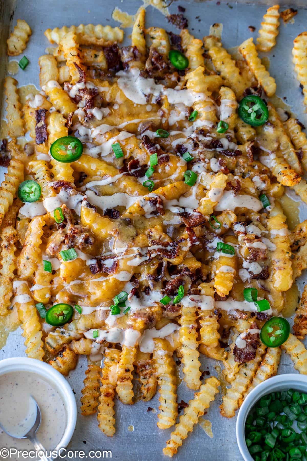 Loaded French Fries on a sheet pan.