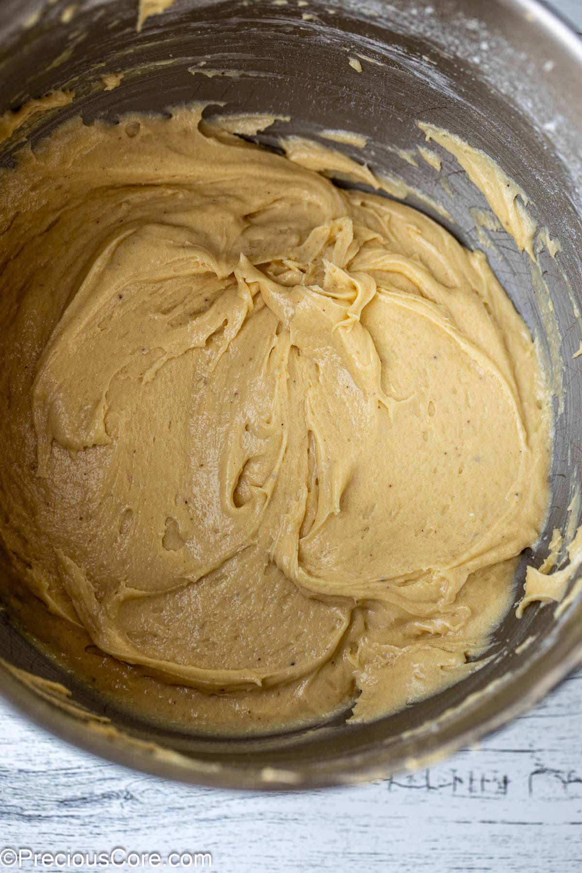 Cake batter in a metal bowl.