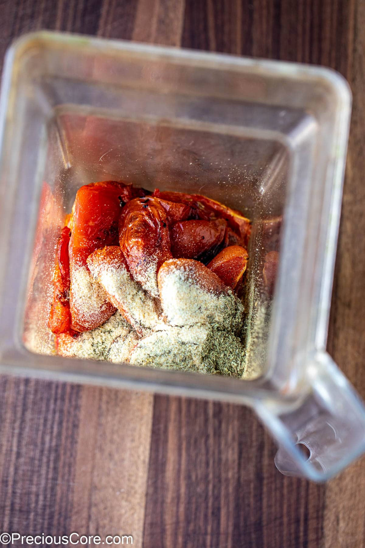 Roasted tomatoes and spices in a blender.