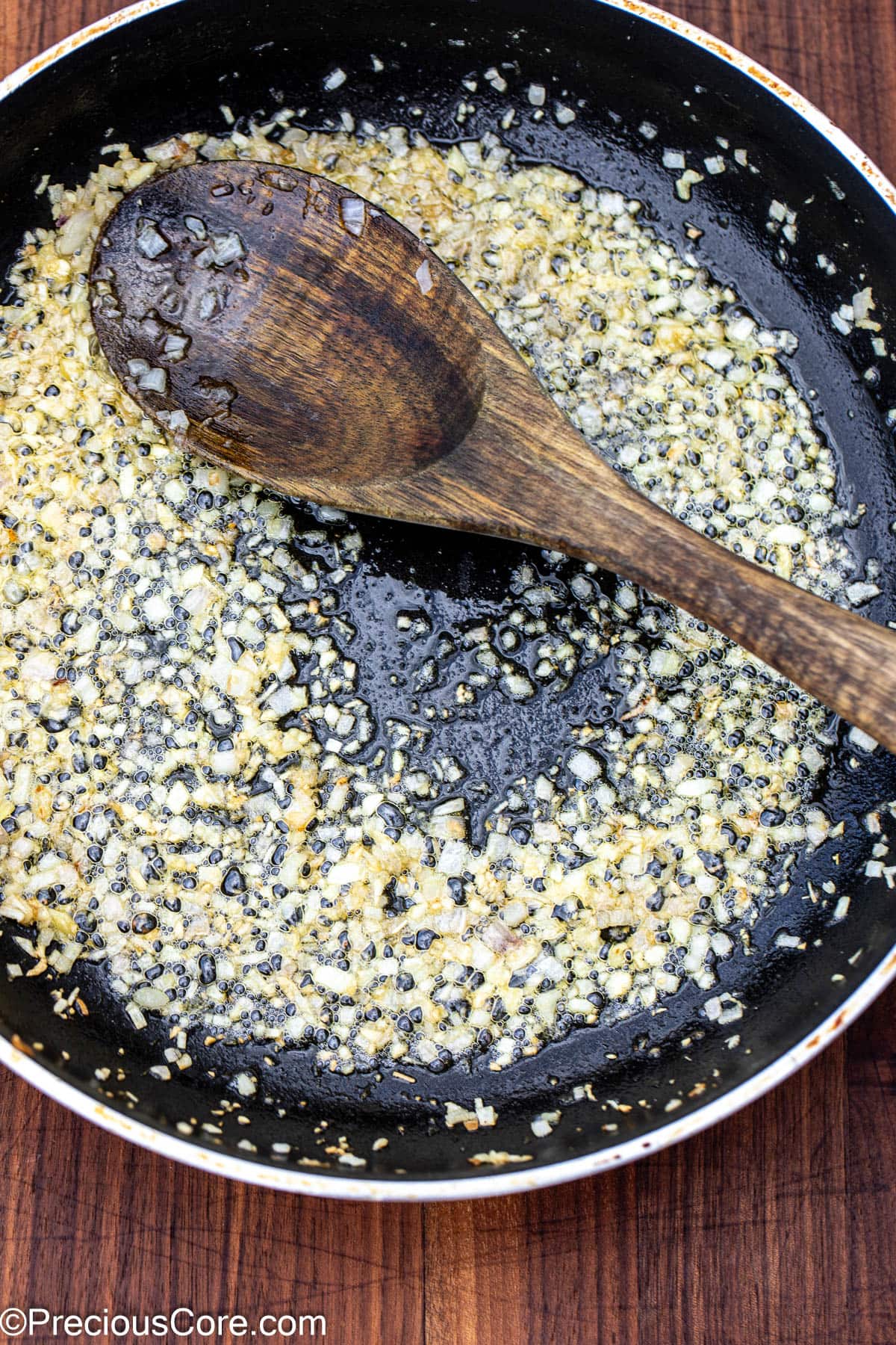 Sautéed shallots and garlic in a skillet.