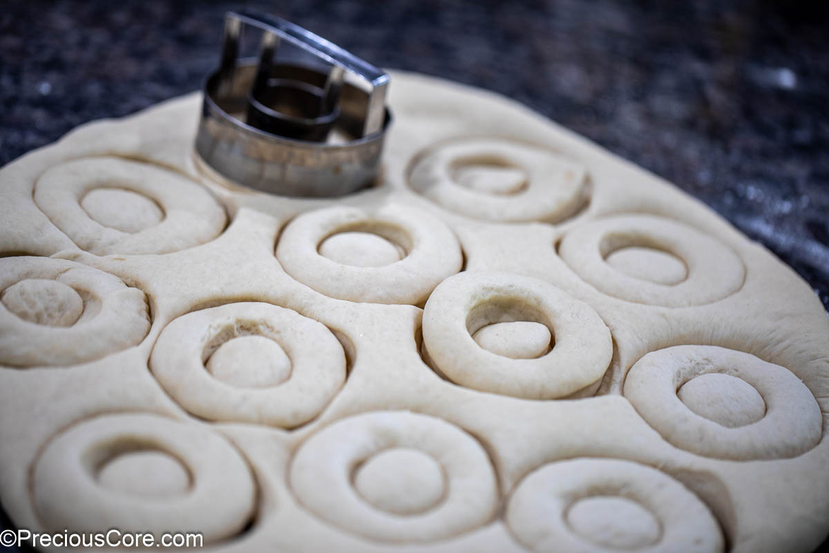 Rolled dough with circles cut out of it.