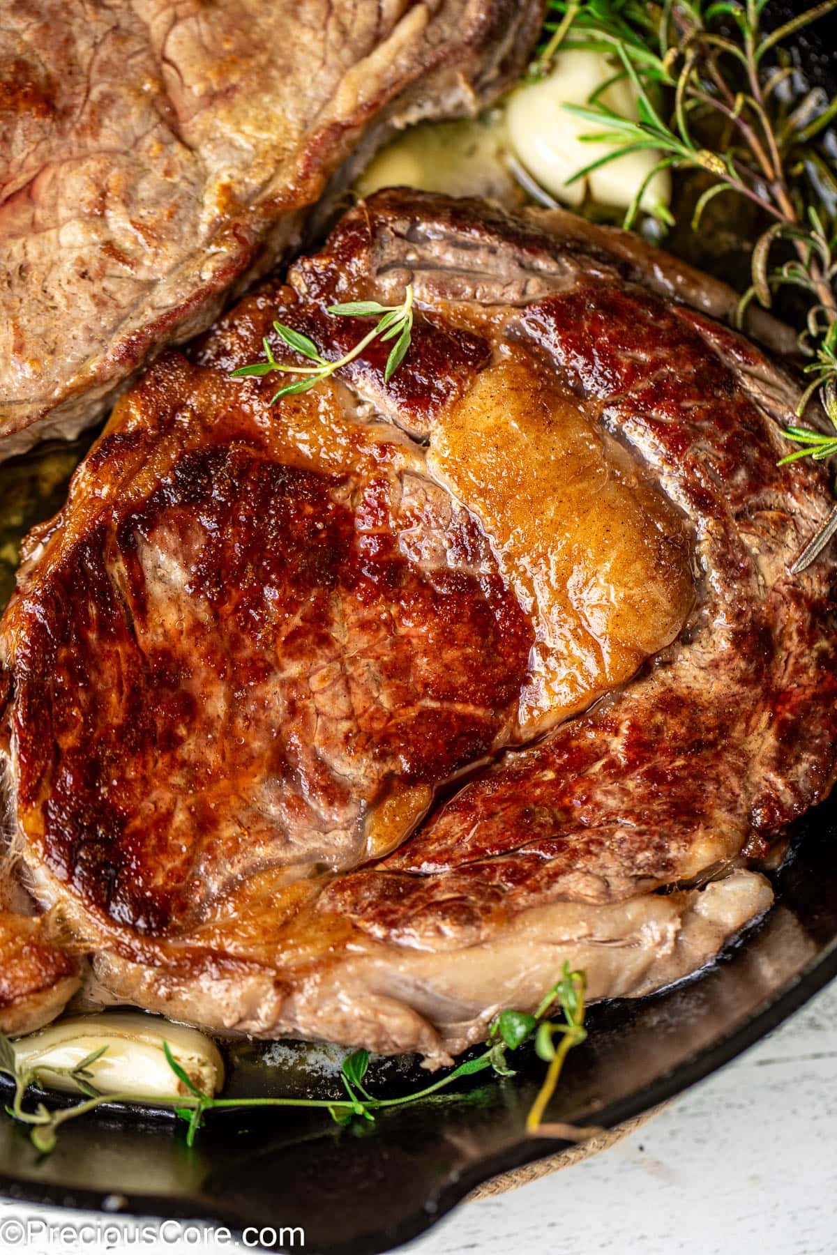 Close up shot of a pan seared ribeye with fat marbling.