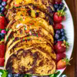 Slices of Sourdough French toast on a white oval plate.