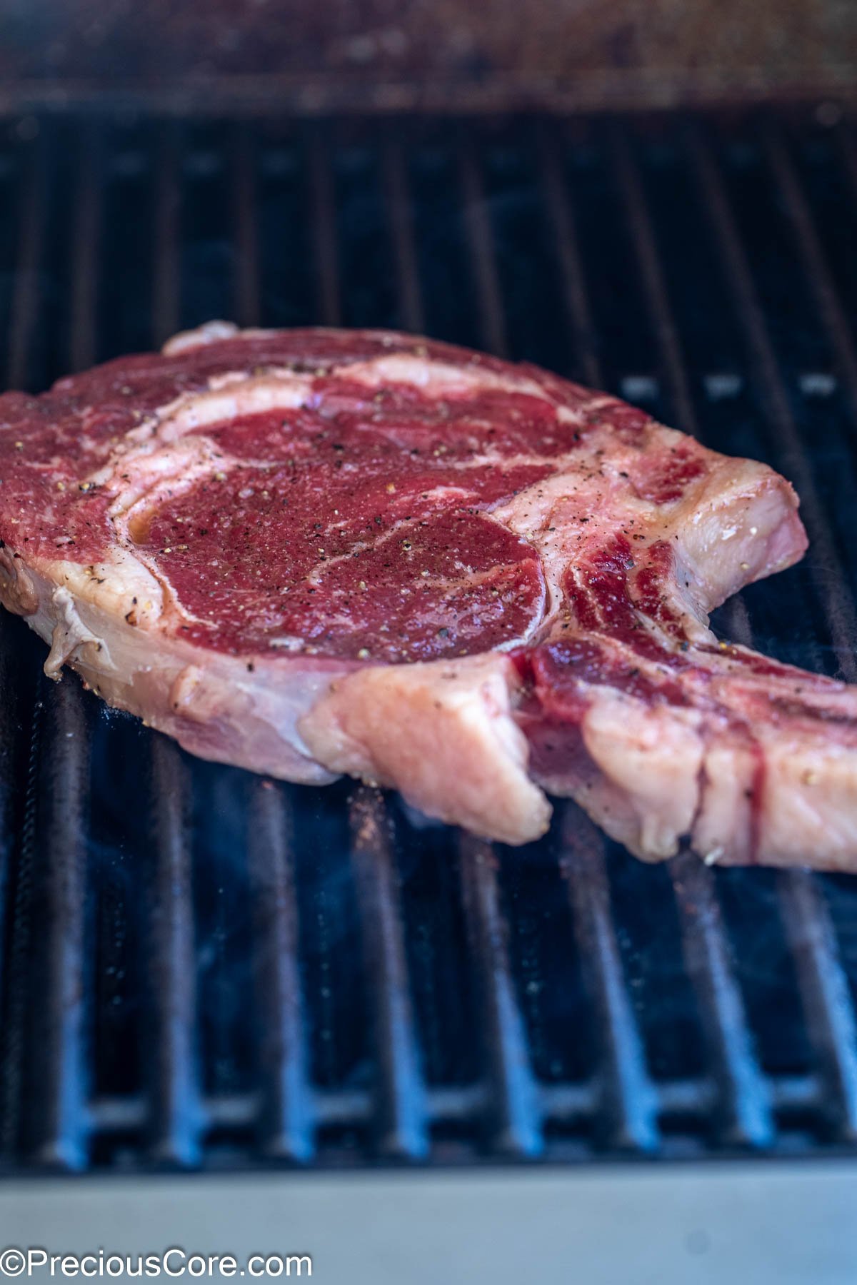 Grilling steak on outside grill.