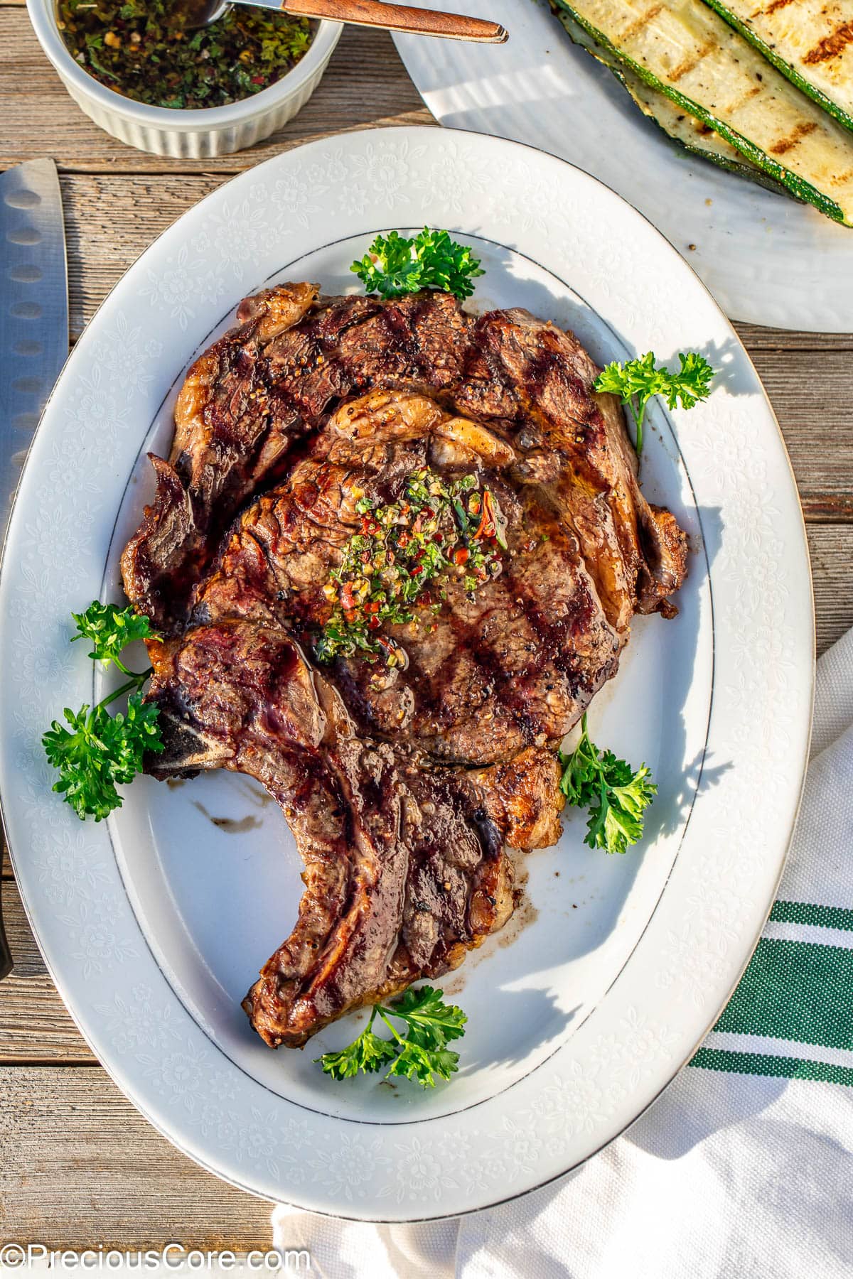 Bone in ribeye served on a white tray.