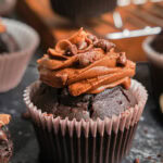 Zoom-in on a chocolate cupcake with chocolate frosting.
