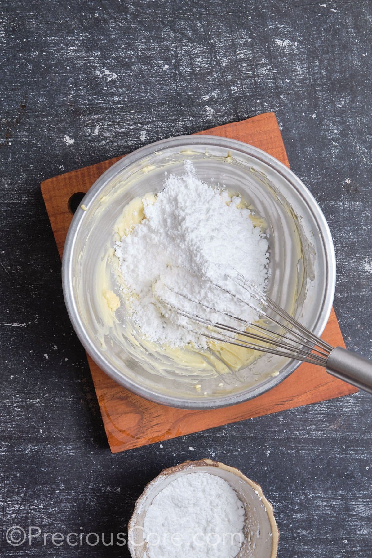 Whipping butter and sugar for frosting.
