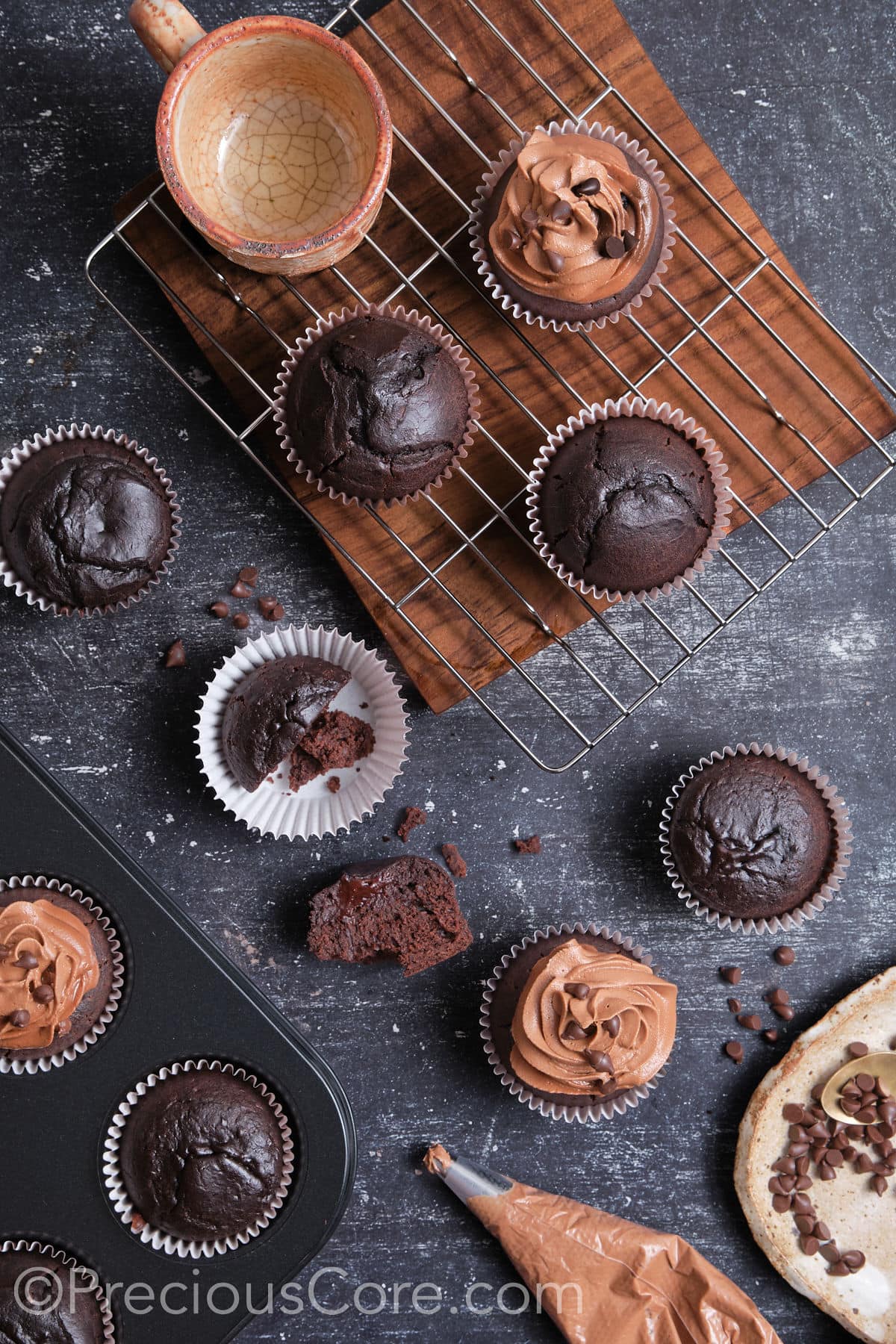 Frosting easy moist chocolate cupcakes.